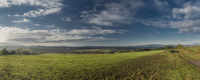 Scenic view of agricultural field against sky