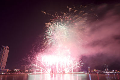 Low angle view of firework display at night