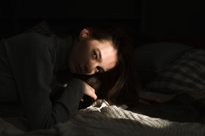 Portrait of woman sitting at home