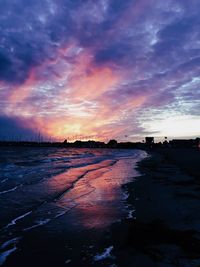 Scenic view of beach against dramatic sky