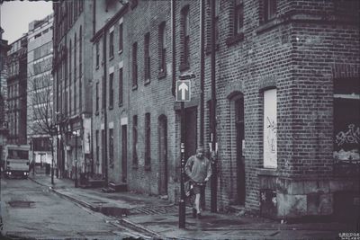 Old building by street in city