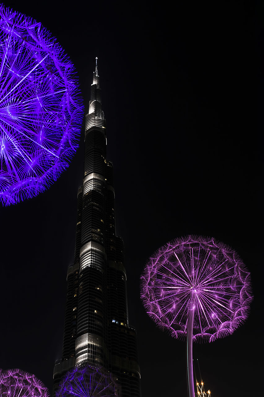 night, illuminated, sky, built structure, building exterior, architecture, low angle view, tower, tall - high, arts culture and entertainment, nature, motion, travel destinations, travel, amusement park, outdoors, no people, purple, amusement park ride, tourism, firework, skyscraper, office building exterior, spire