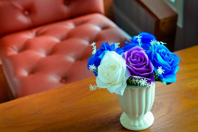 Close-up of roses in vase on table