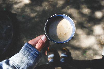 Close-up of hand holding coffee cup