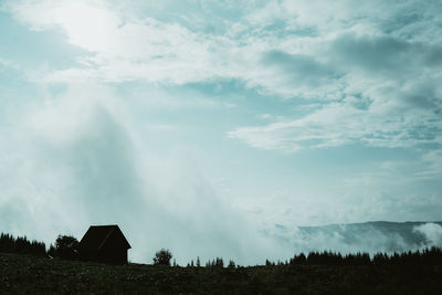 Panoramic view of land and houses against sky