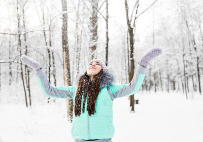 Full length of woman standing on snow covered land