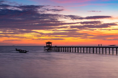 Silhouette pier on sea against sky during sunset