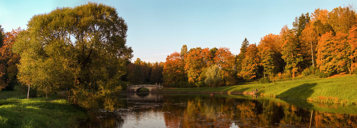 Scenic view of lake by trees against sky during autumn