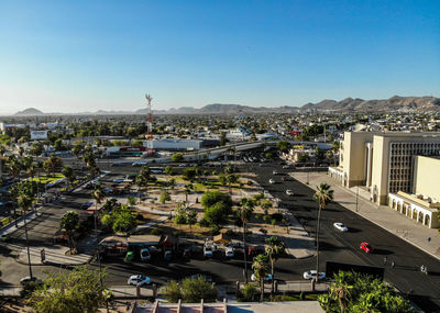 High angle view of city street and buildings against sky