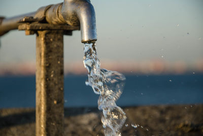 Close-up of water flowing from tap