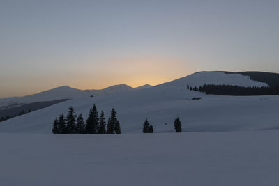 Scenic view of snowcapped mountains against sky during sunset