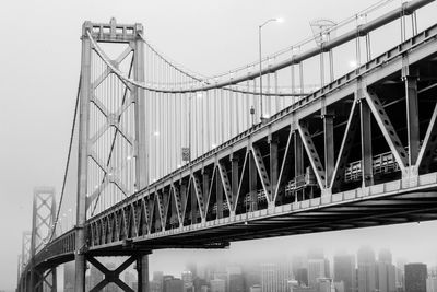 Low angle view of oakland bay bridge in city