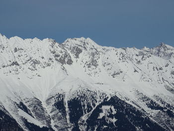 Scenic view of snowcapped mountains against clear sky