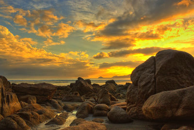 Scenic view of rocks against sky during sunset