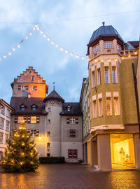 Low angle view of illuminated buildings against sky