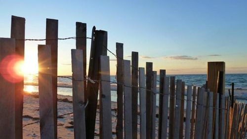 Pier on sea at sunset