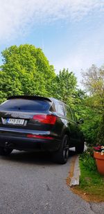 Car on road against sky in city