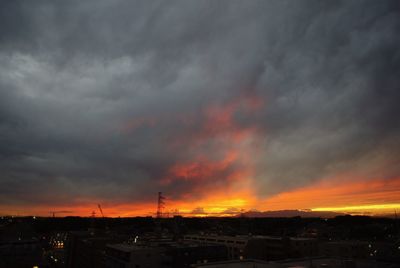 Storm clouds over city during sunset