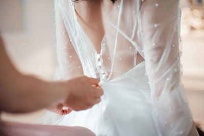 Bridesmaid grooming bride