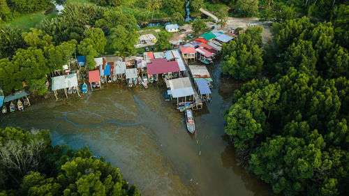 High angle view of river amidst trees in city