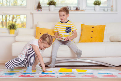 Boy sitting on sofa at home