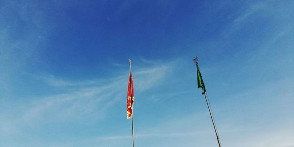 Low angle view of flags against sky