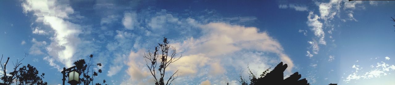 low angle view, sky, cloud - sky, blue, cloud, silhouette, cloudy, built structure, nature, beauty in nature, building exterior, architecture, high section, tranquility, outdoors, tree, no people, scenics, day, sunlight