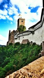 Low angle view of building against cloudy sky