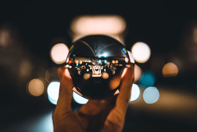 Close-up of man photographing illuminated camera