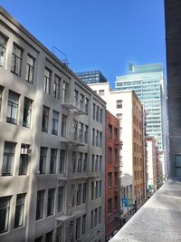 Buildings in city against clear sky