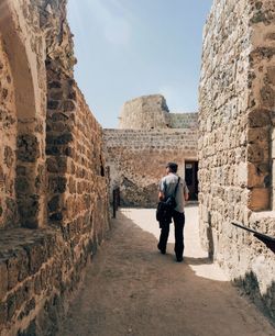 Full length of man walking amidst old ruin