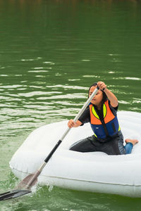 Young woman in boat on lake