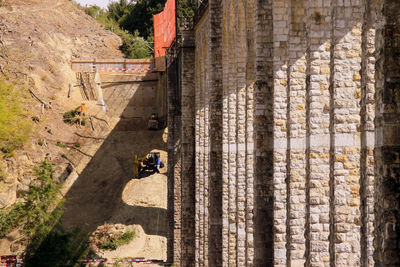 High angle view of people riding motorcycle on rock