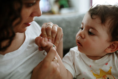 Cute baby boy with mother at home