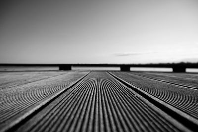 Surface level of wooden pier against clear sky