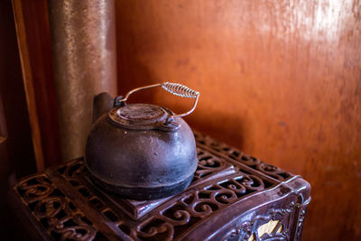 High angle of antique tea kettle on wooden stove