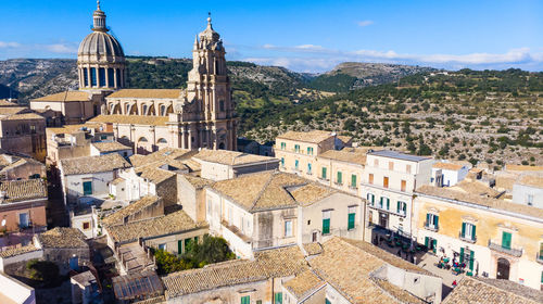 High angle view of buildings in town against sky