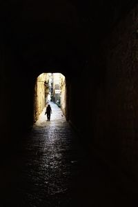Silhouette man in tunnel