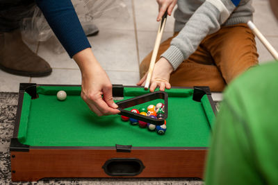 Midsection of man playing with ball on table