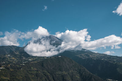 Scenic view of mountains against cloudy sky