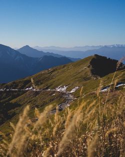 Scenic view of mountains against clear blue sky