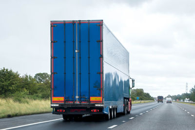 Vehicles on road against sky