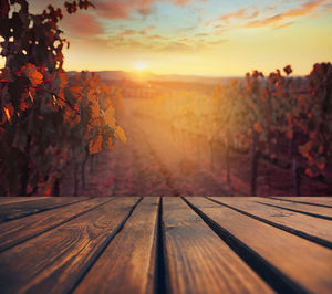 Close-up of bench against sky during sunset