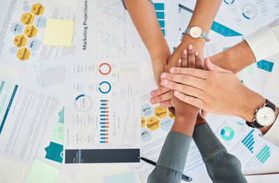 Cropped image of business people working on table