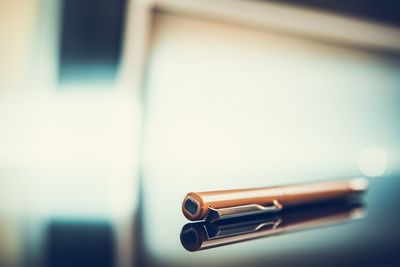 Close-up of camera on table against white background