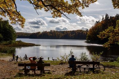 Scenic view of lake by trees against sky