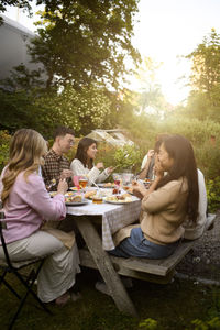 Friends using mobile phone while sitting at restaurant