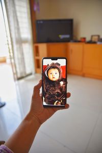 Portrait of man photographing with mobile phone