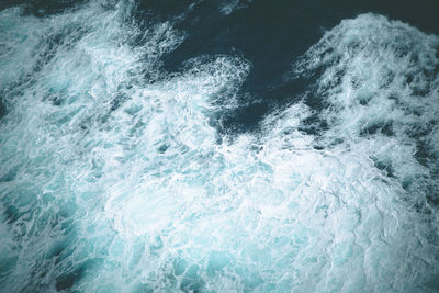 View of the foamy and blue sea from a cruise