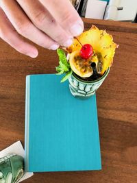 High angle view of person holding food on table